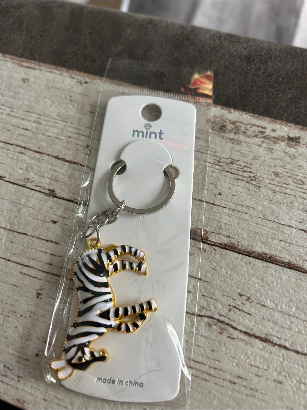 5/$25 Mint Zebra Enamel Keyring – Black, White & Gold